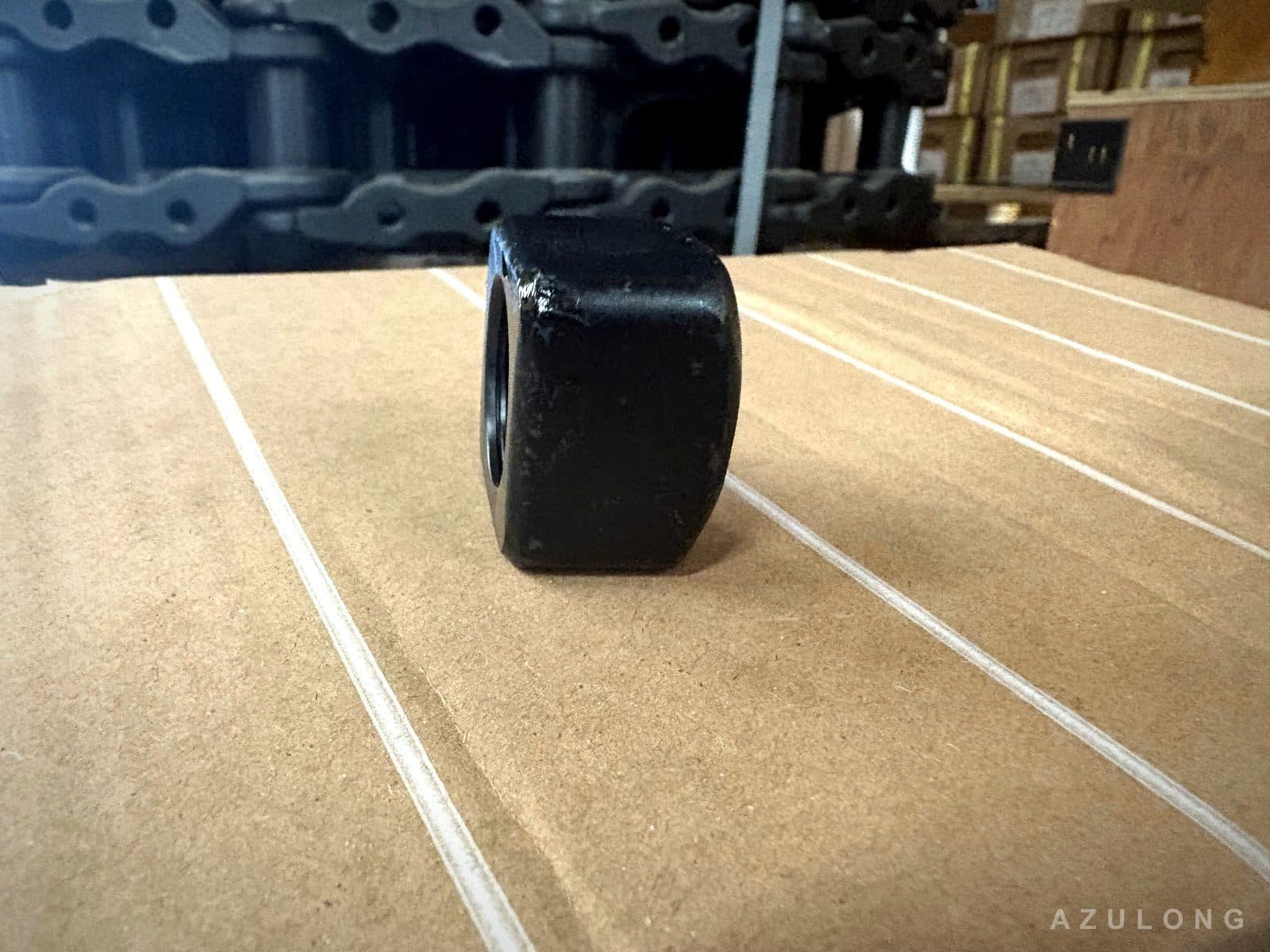 Square track nut with track chain assembly in background