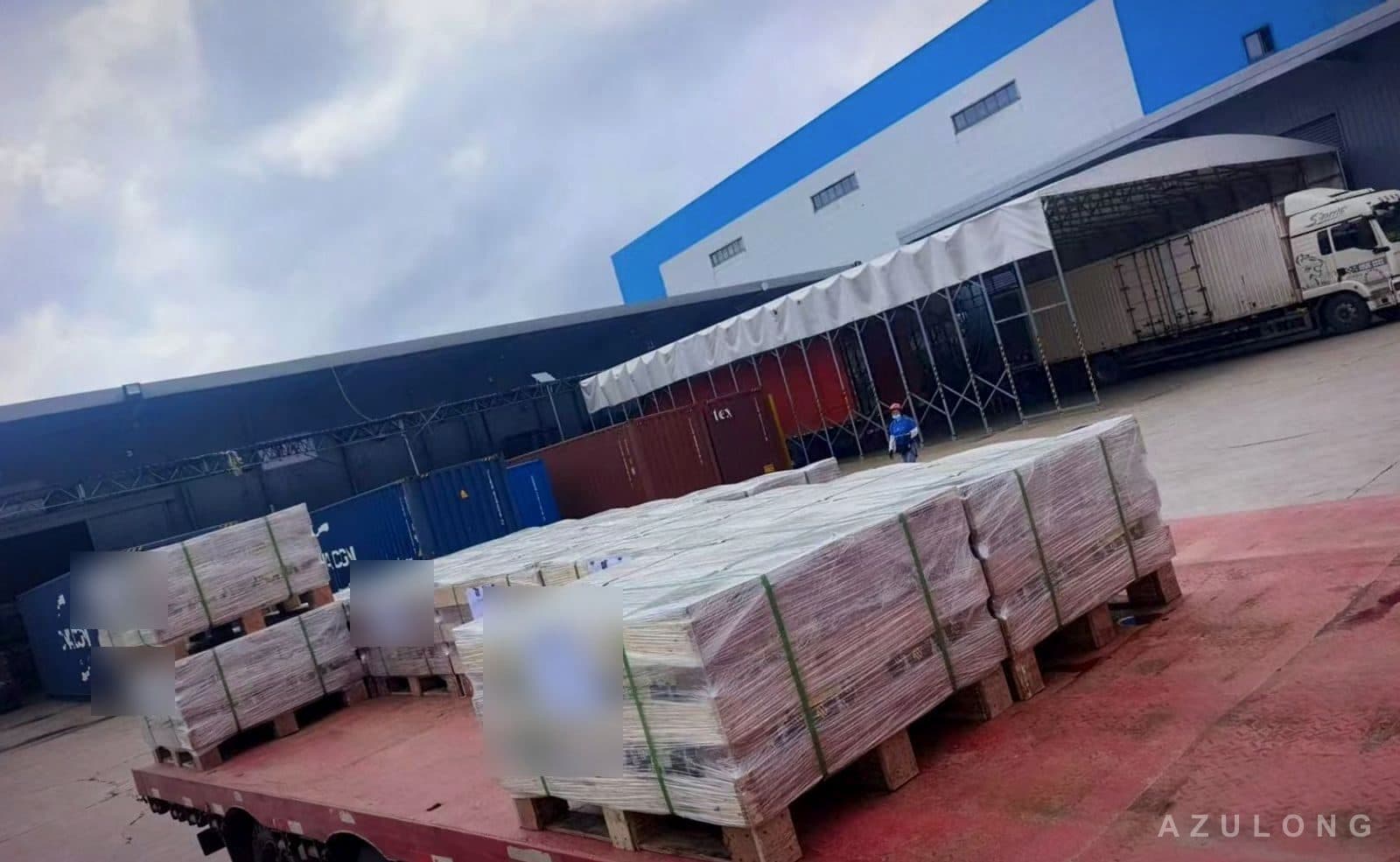 Wrapped pallets on a flatbed truck arriving at the warehouse